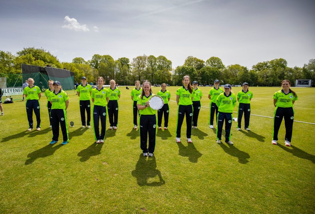Cricket Ireland women's team showcasing their new gear with Hanley Energy sponsorship.